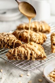 the scones on a cooling rack being drizzled with icing