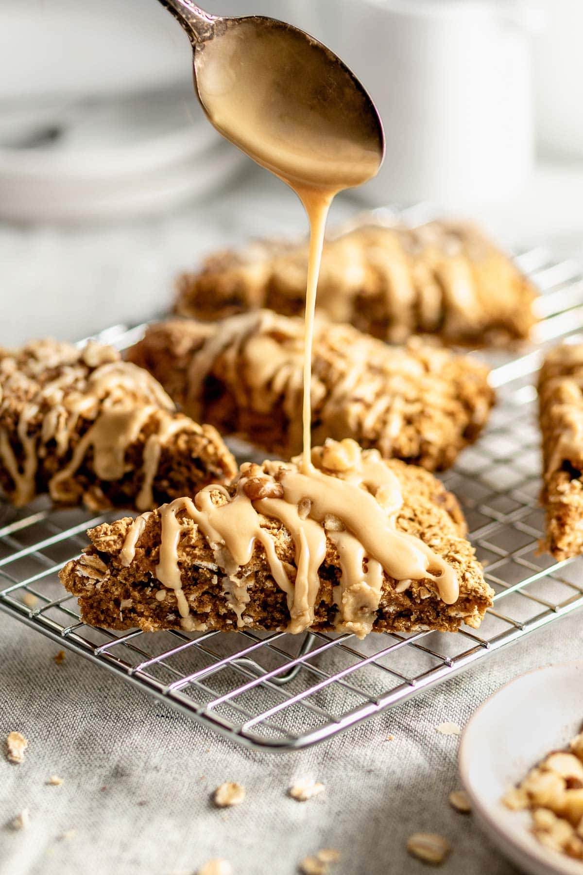 the scones on a cooling rack being drizzled with icing