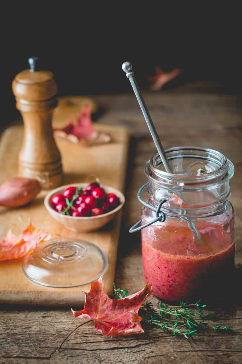 Cranberry Vinaigrette in jar next to serving board