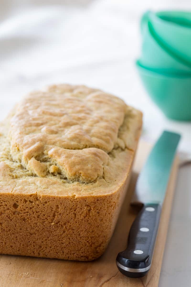 a loaf of gluten free quick bread on a cutting board