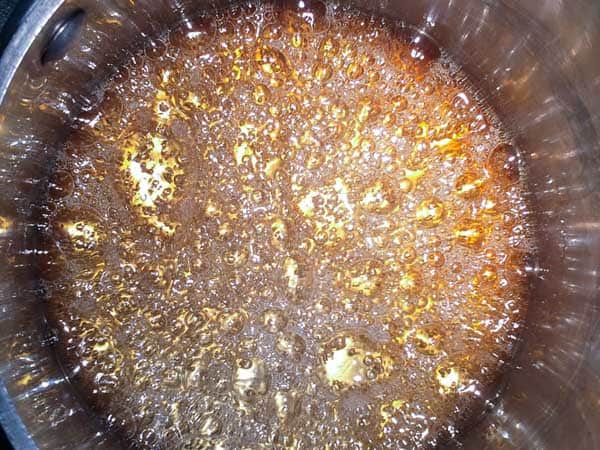 A close up of bubbling sugar that is caramelizing