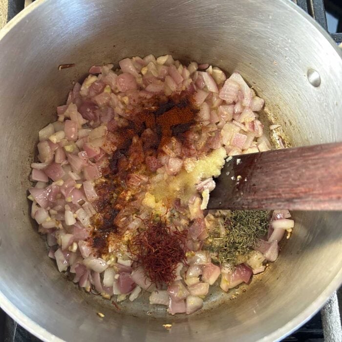 the spices sprinkled on top of the onion and garlic