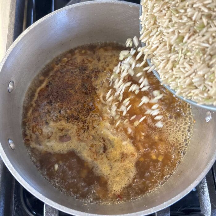 Add the rice to the simmering broth and return the mixture to a simmer