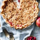 cranberry crumb apple pie overhead on a blue napkin