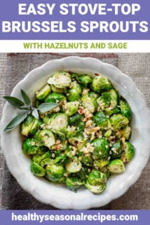 close-up overhead of brussels sprouts in a white bowl with a sprig of sage