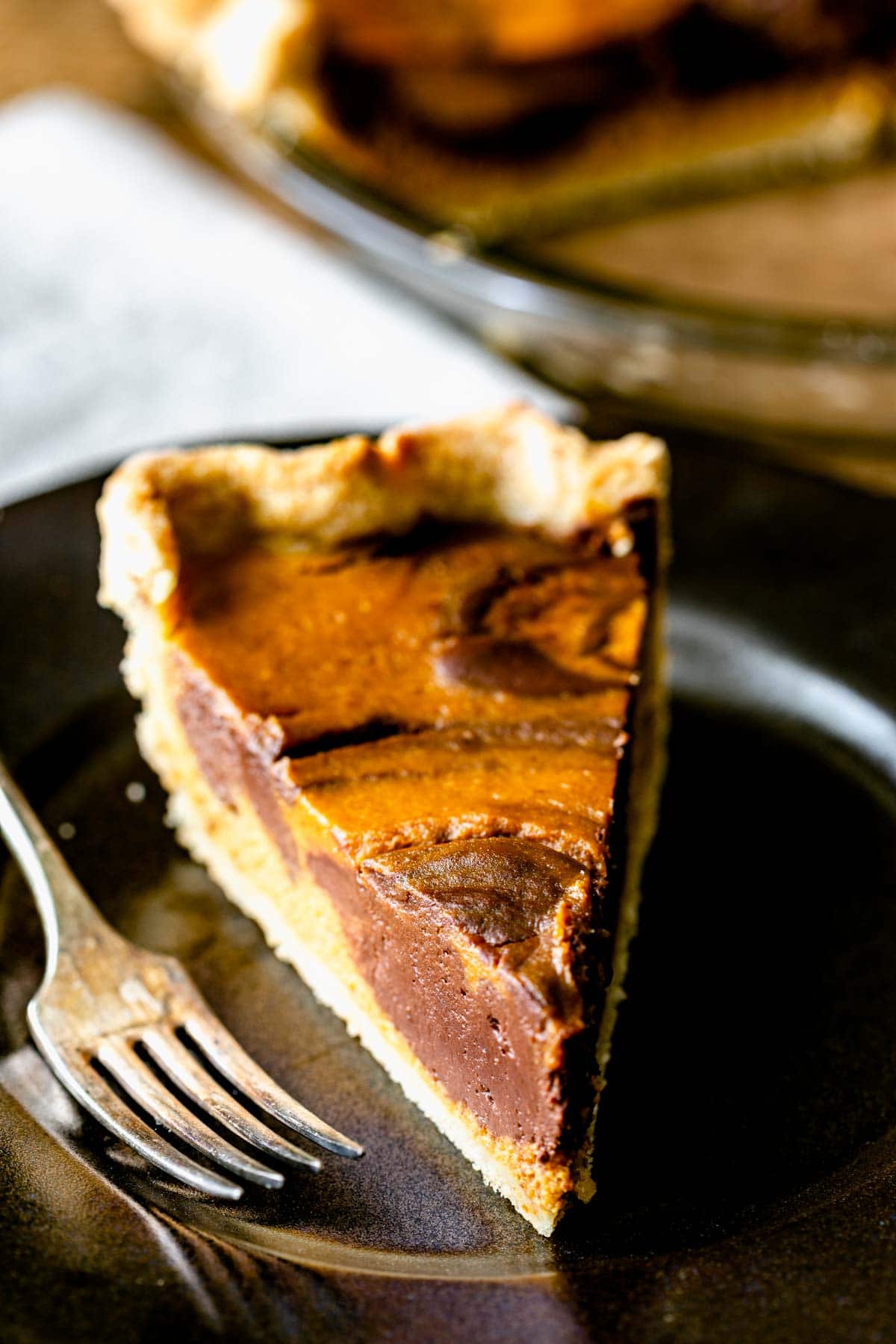 a single slice of the pie on a black plate