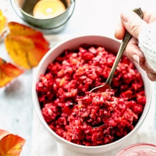 Cranberry Relish on a spoon in hand with white sweater
