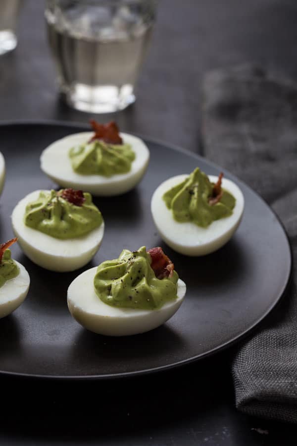 Spinach and Bacon Deviled Eggs recipe on a serving platter
