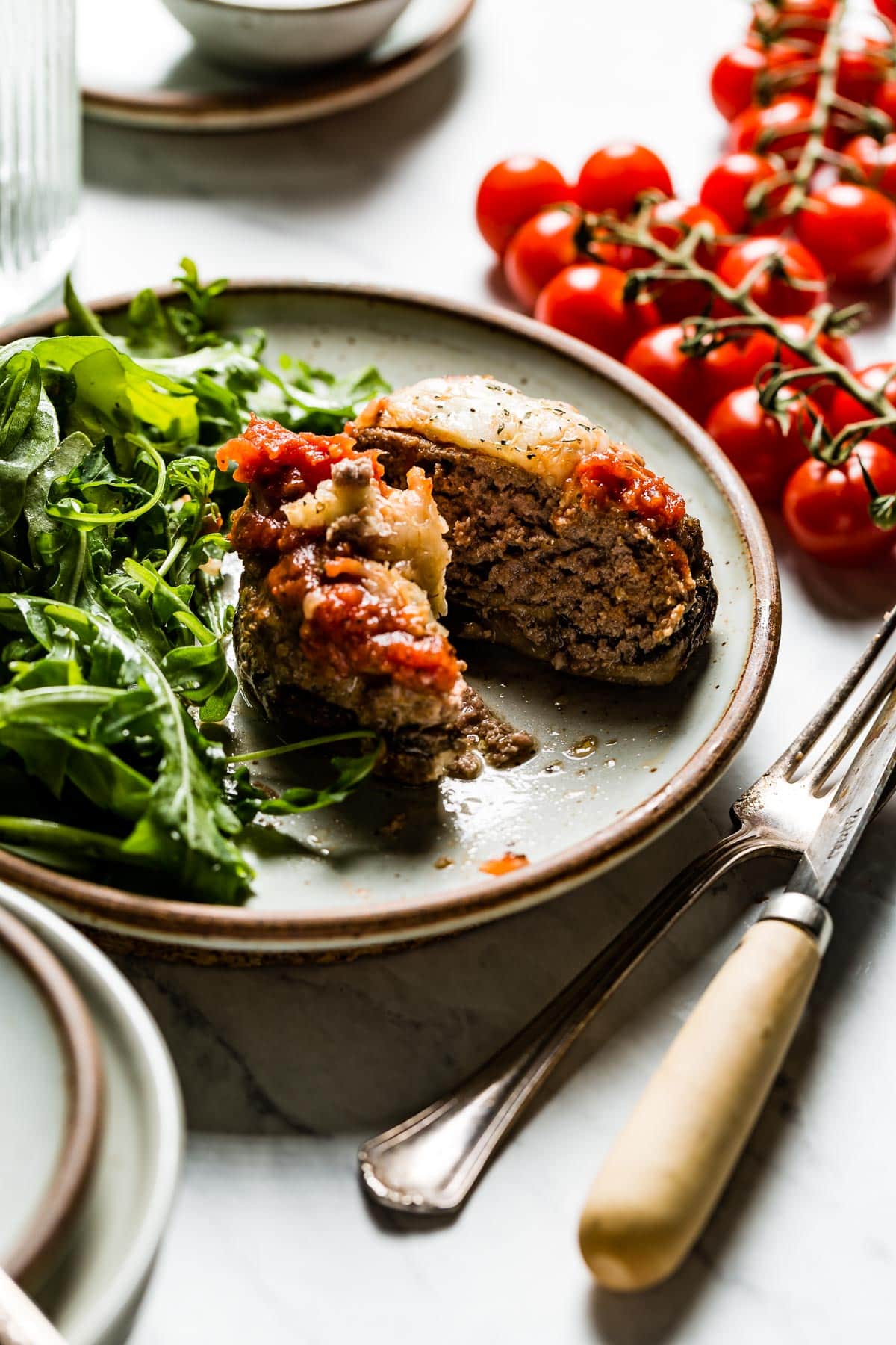 a stuffed mushroom that has been cut into so you can see the texture of the filling.