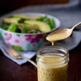 apple cider vinegar salad dressing in a jar with a spoon