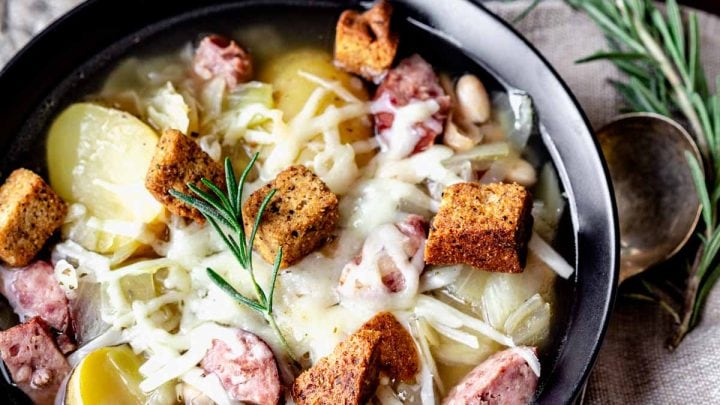 kielbasa soup in a black bowl