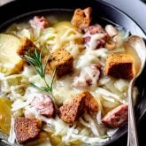 kielbasa and cabbage soup in black bowl
