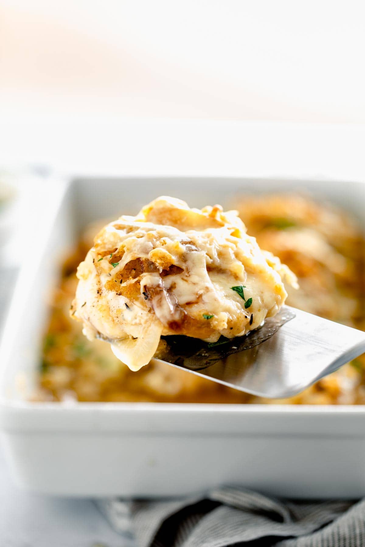 Baked Fish topped with breadcrumbs and cheese on a spatula