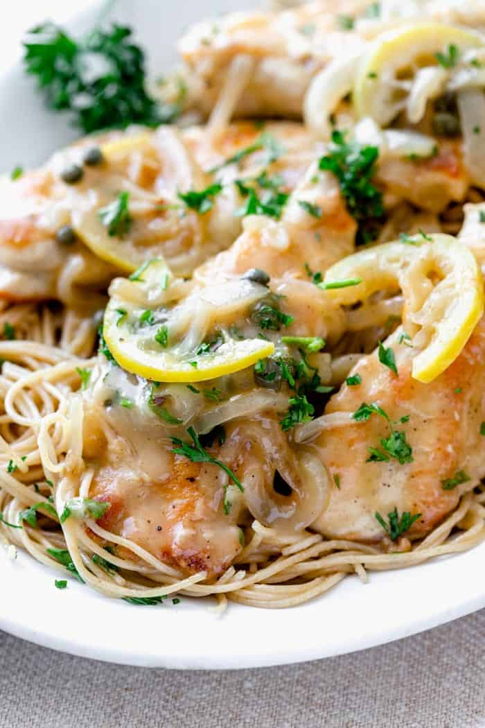 a close up of chicken piccata
