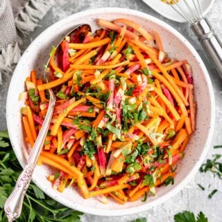 carrot and radish slaw in a white bowl from overhead