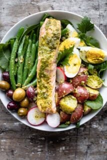 a close up overhead of salmon nicoise with pesto