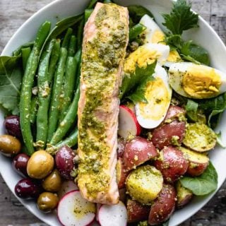 a close up overhead of salmon nicoise with pesto