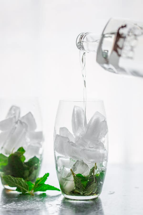 Spritzers made with mint, maple and vodka and ice
