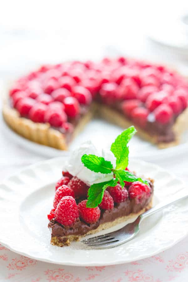 Healthy Raspberry Tart Recipe with Chocolate with a slice on a plate