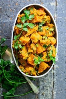 Paleo Sweet Potato Salad in a white dish on a blue surface
