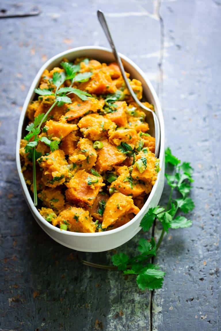 Paleo Sweet Potato Salad in a white dish on a blue surface