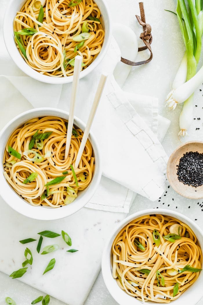 Sesame Noodles in white bowls with black sesame seeds