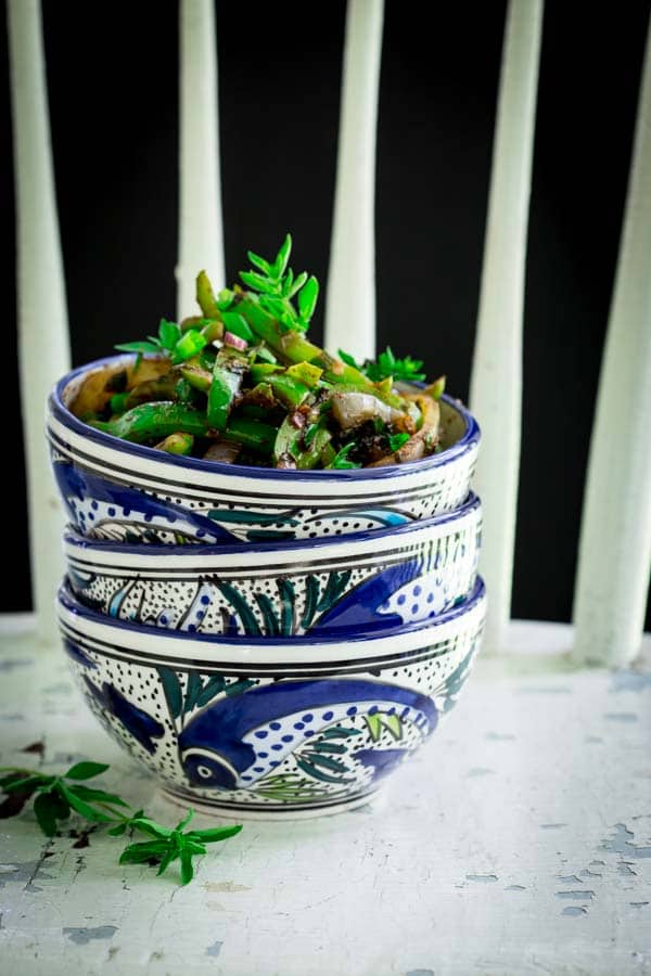 sauteed peppers in a stack of bowls