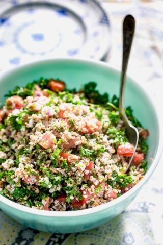 a teal bowl with tabbouleh in it