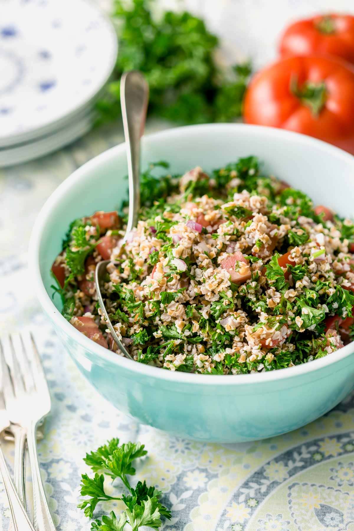 side view of teal bowl with tabbouleh