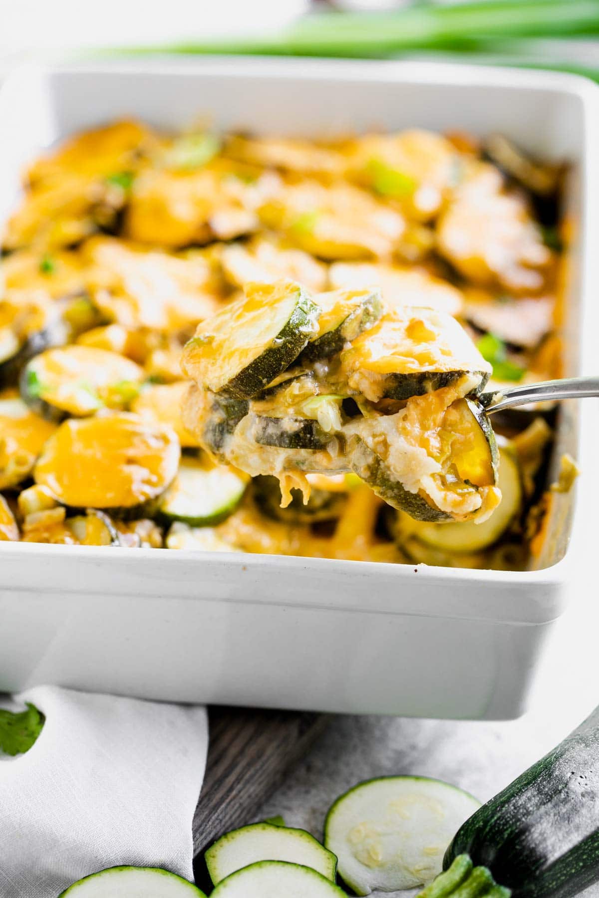 scoop of casserole held in front of the casserole