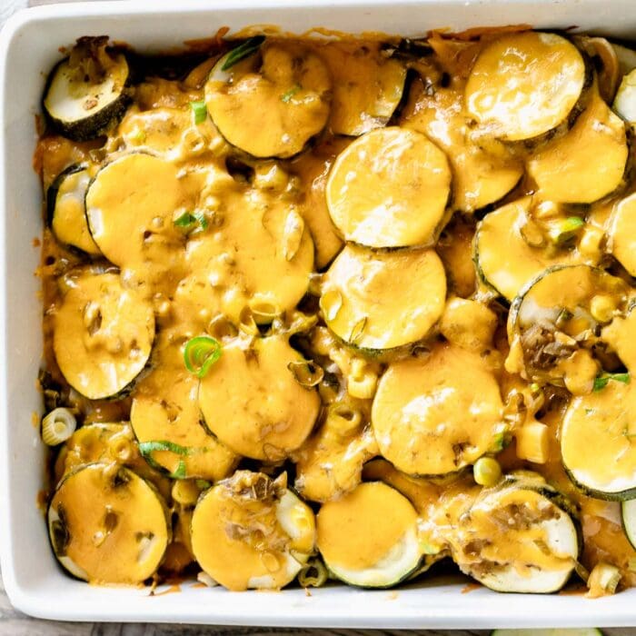 A dish is filled with Zucchini casserole with melted cheese on top