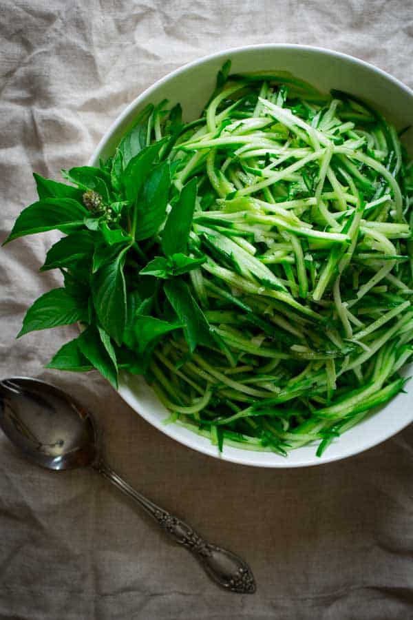 clean eating cucumber noodles with lemon basil in a serving bowl