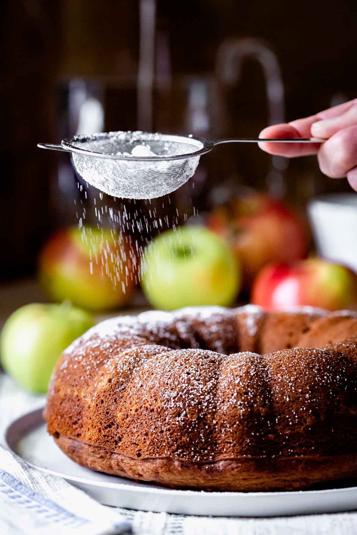sifting powdered sugar over the bundt