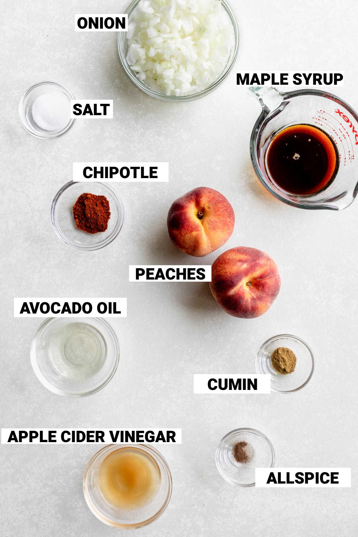 Ingredients for chipotle peach barbecue sauce including peaches, onions, maple syrup, and chipotle seasoning
