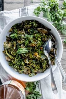 sauteed kale with cider vinegar in circular white serving dish