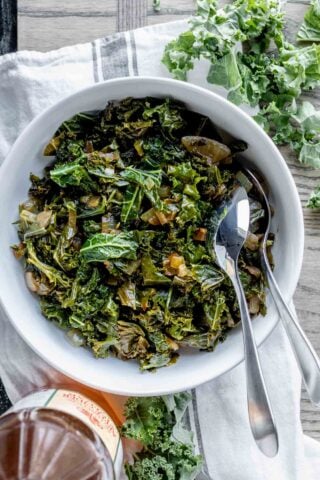 sauteed kale with cider vinegar in circular white serving dish