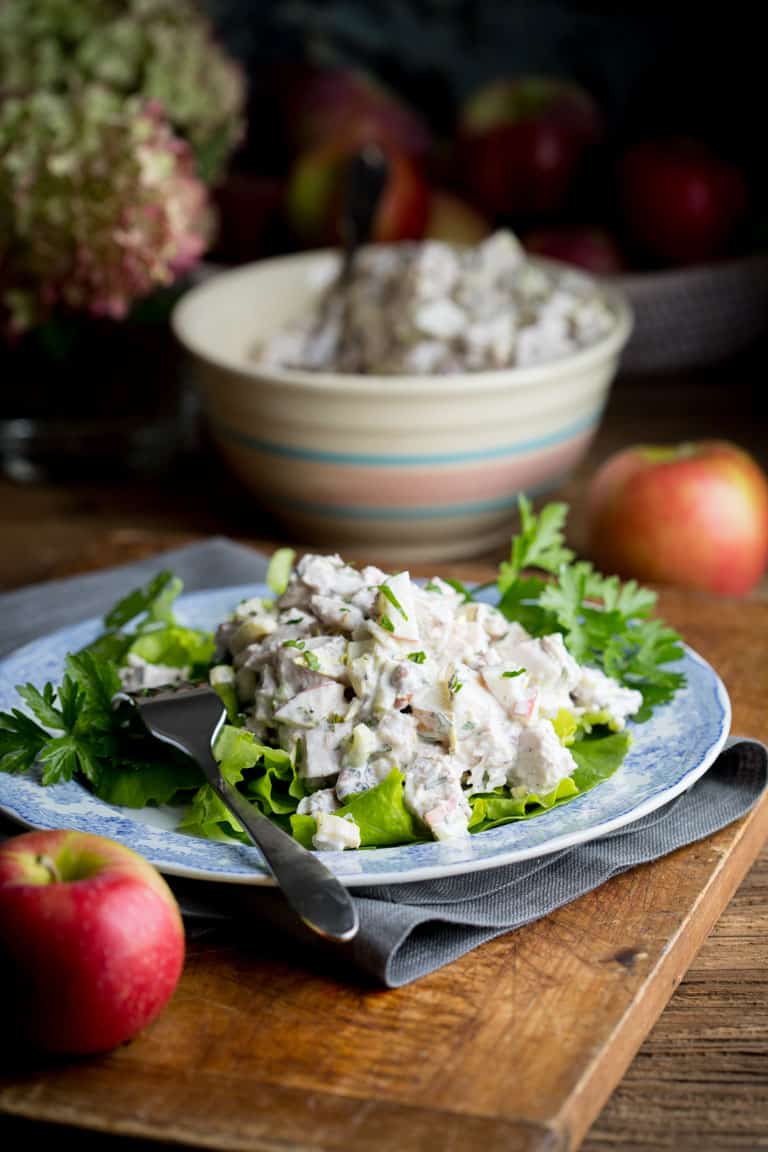 Waldorf Chicken Salad on a place alongside an apple