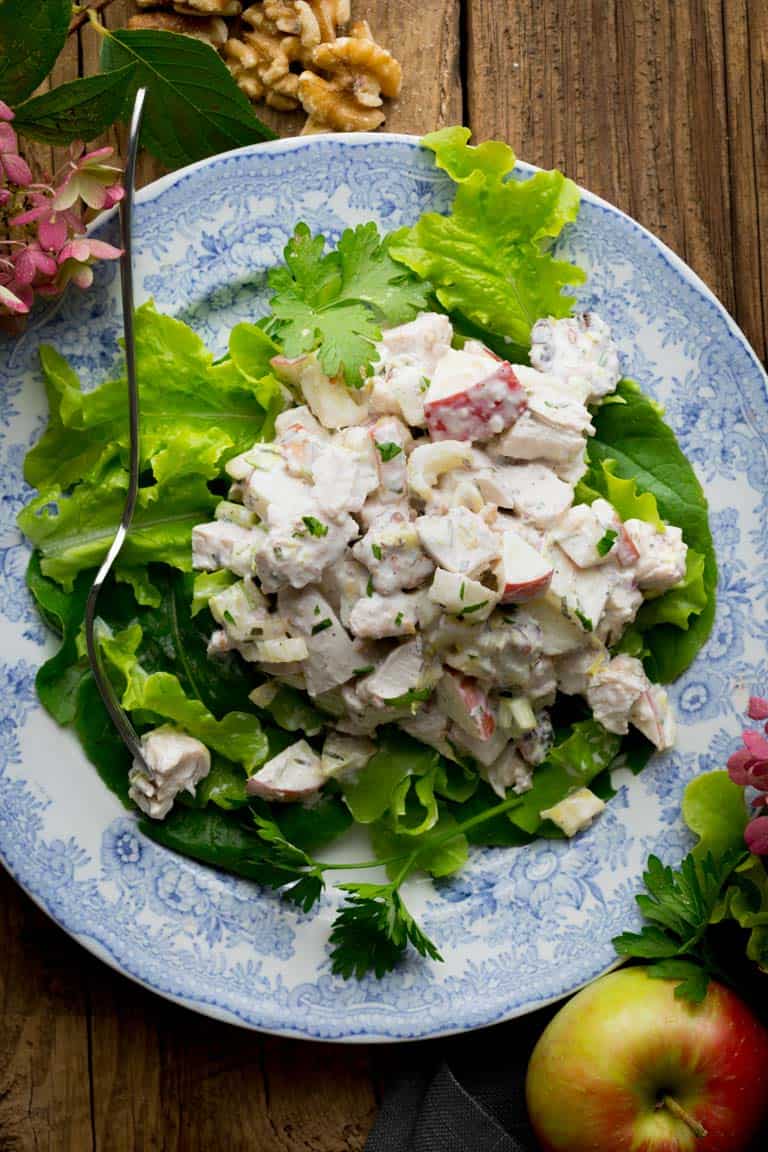 Chicken Waldorf Salad on a blue plate with lettuce