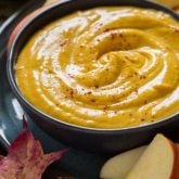 close up of pumpkin dip with apple slices
