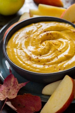 close up of pumpkin dip with apple slices
