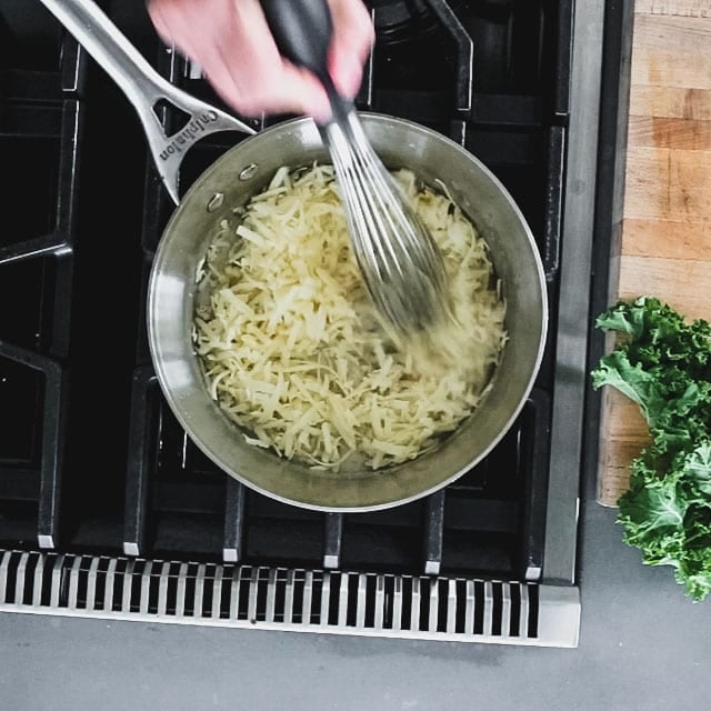 whisking cheese into sauce