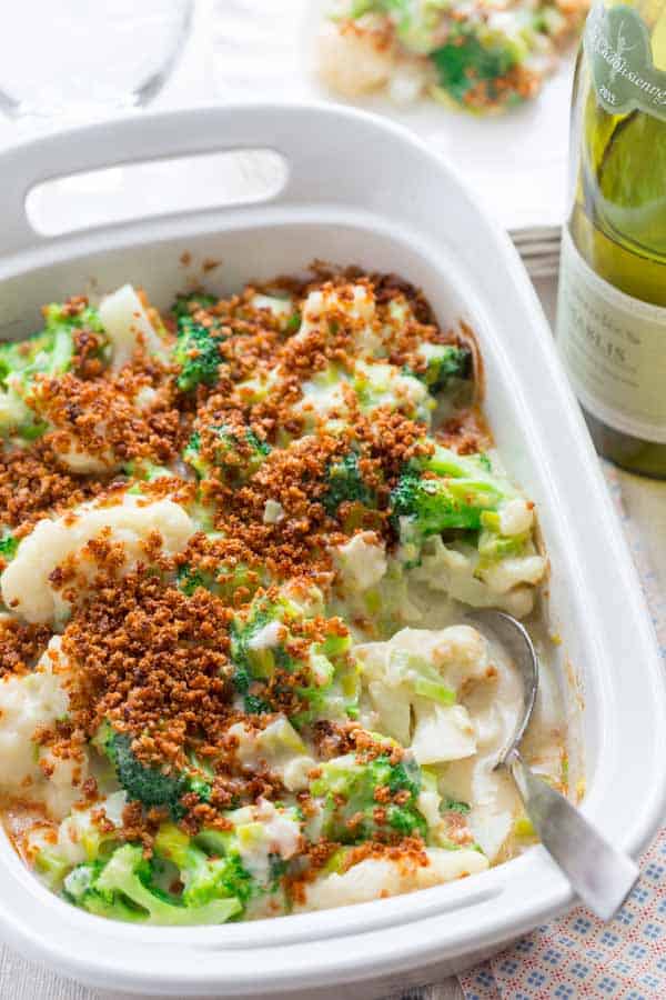 broccoli and cauliflower casserole in a white ceramic casserole dish with handles