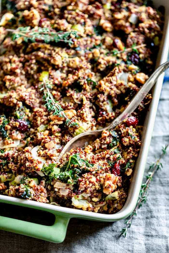 A close up of a baking dish filled with gluten free Thanksgiving stuffing with kale, quinoa and walnuts