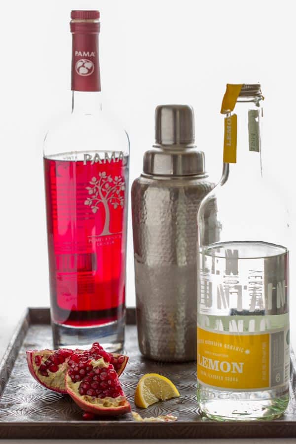 An image of the ingredients needed for a pomegranate martini with pomegranate liqueur and citron vodka.