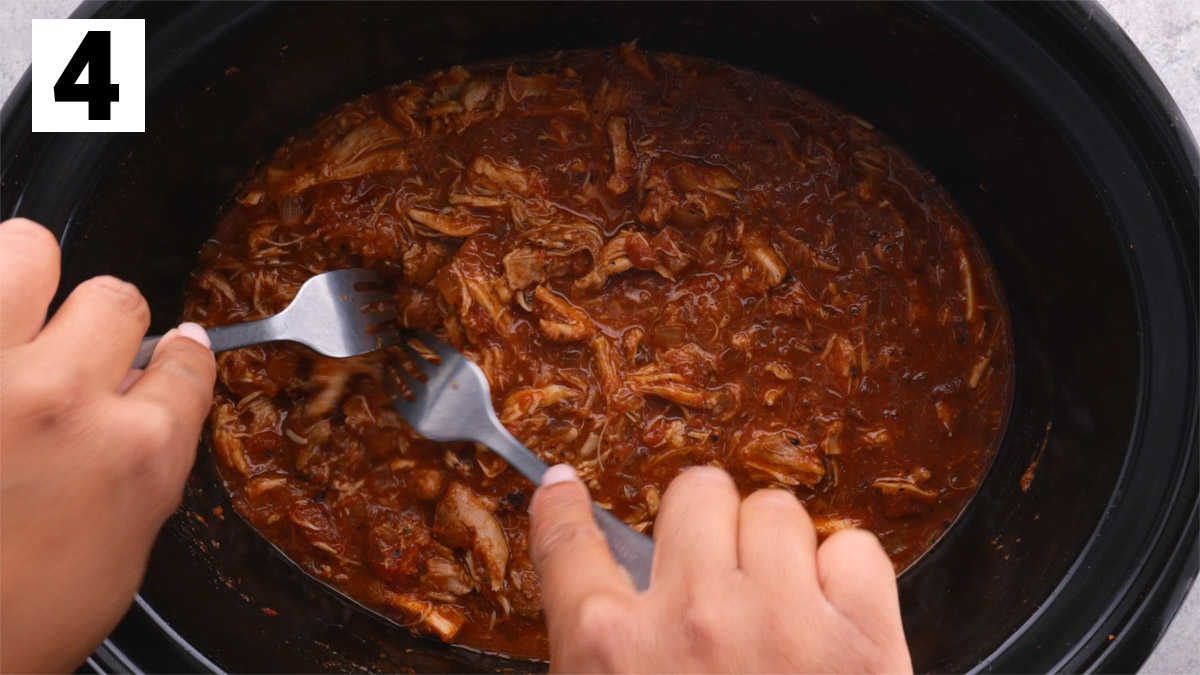 shredding the chicken with two forks
