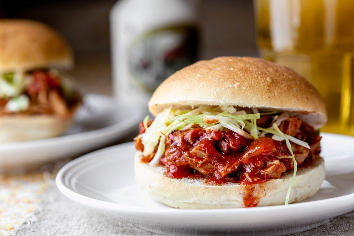 side view of two sandwiches and a bottle of syrup