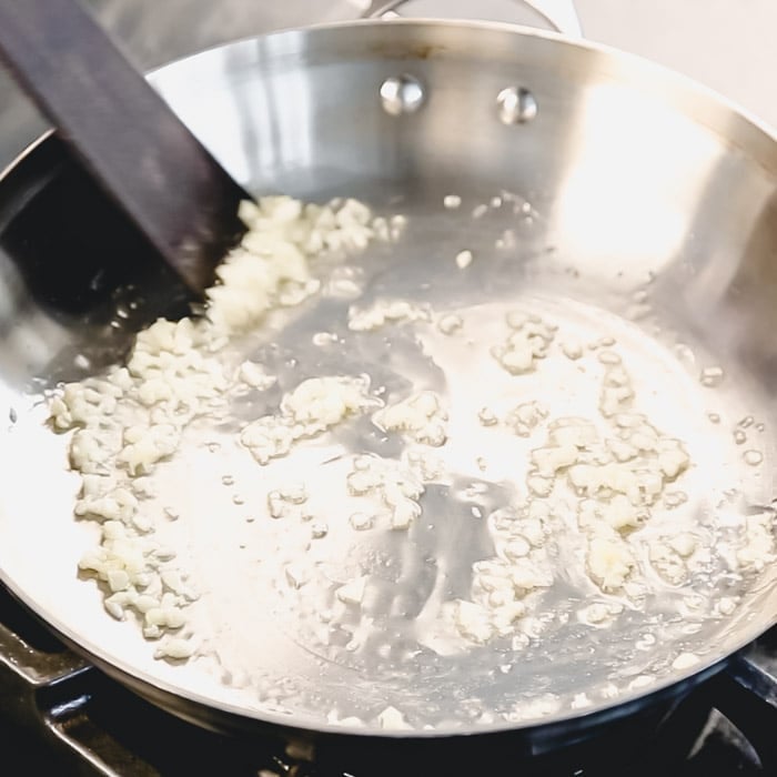 While the broccoli steams, cook the garlic in olive oil in a skillet.
