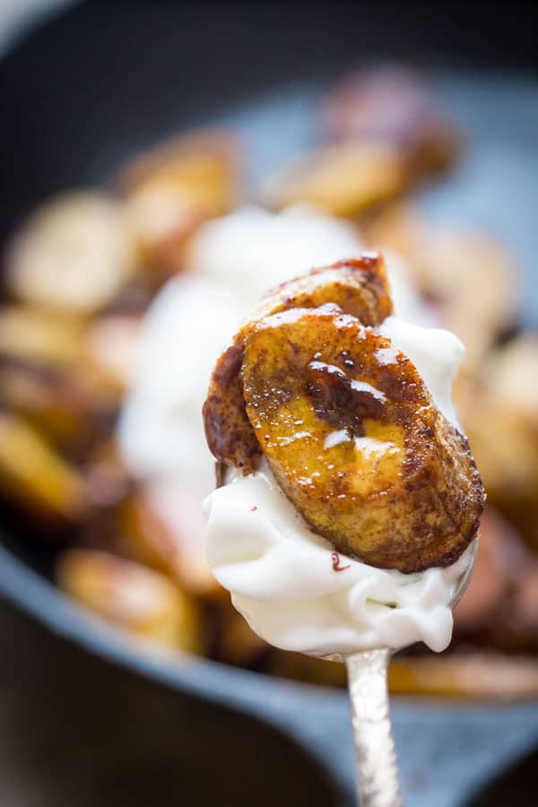 roasted plantains on a spoon with whipped cream