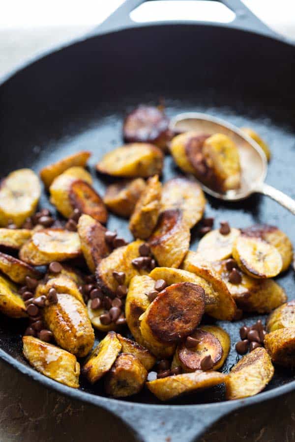 Maple Allspice Roasted Plantains in a skillet with chocolate chips