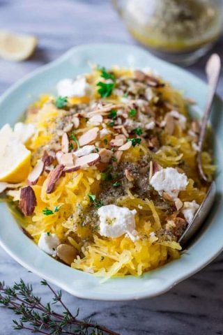 a blue dish with spaghetti squash topped with cheese